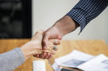 Agent and employee shake hands for agreement