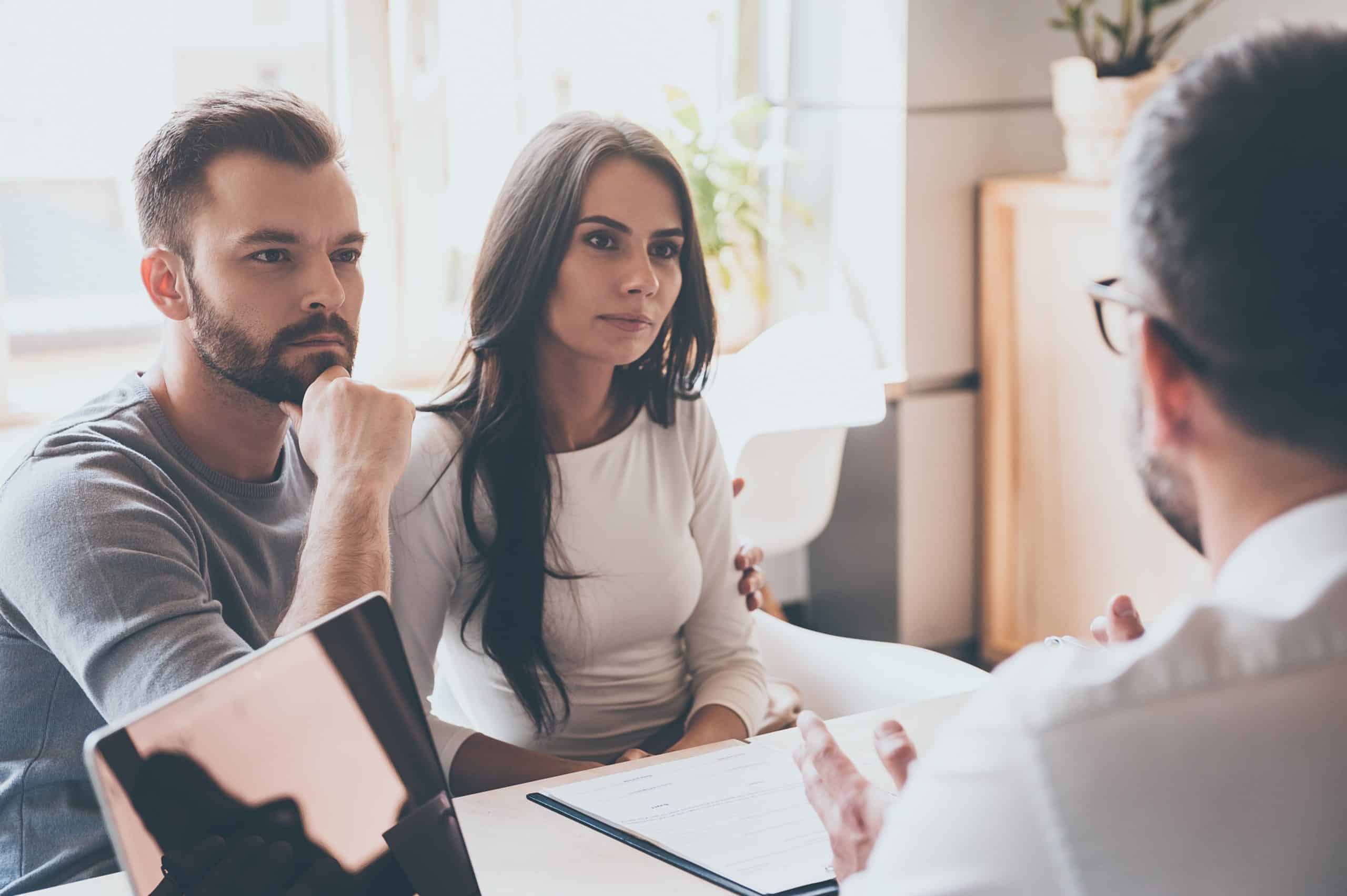 A couple carefully listening to the financial advisor