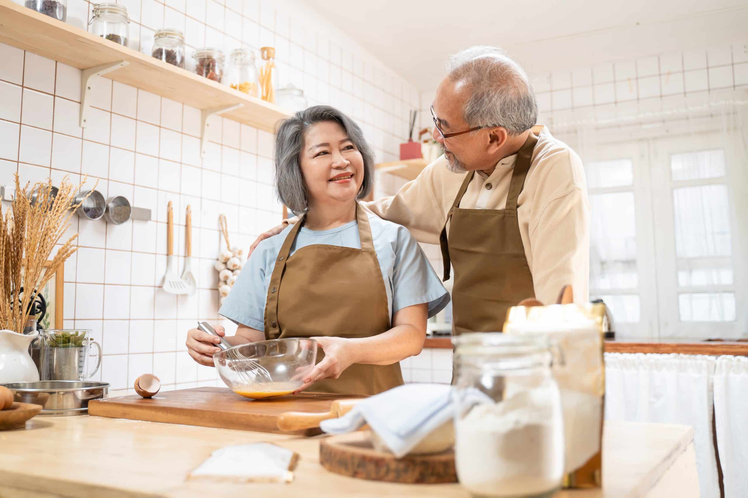 An elderly couple looking at each other